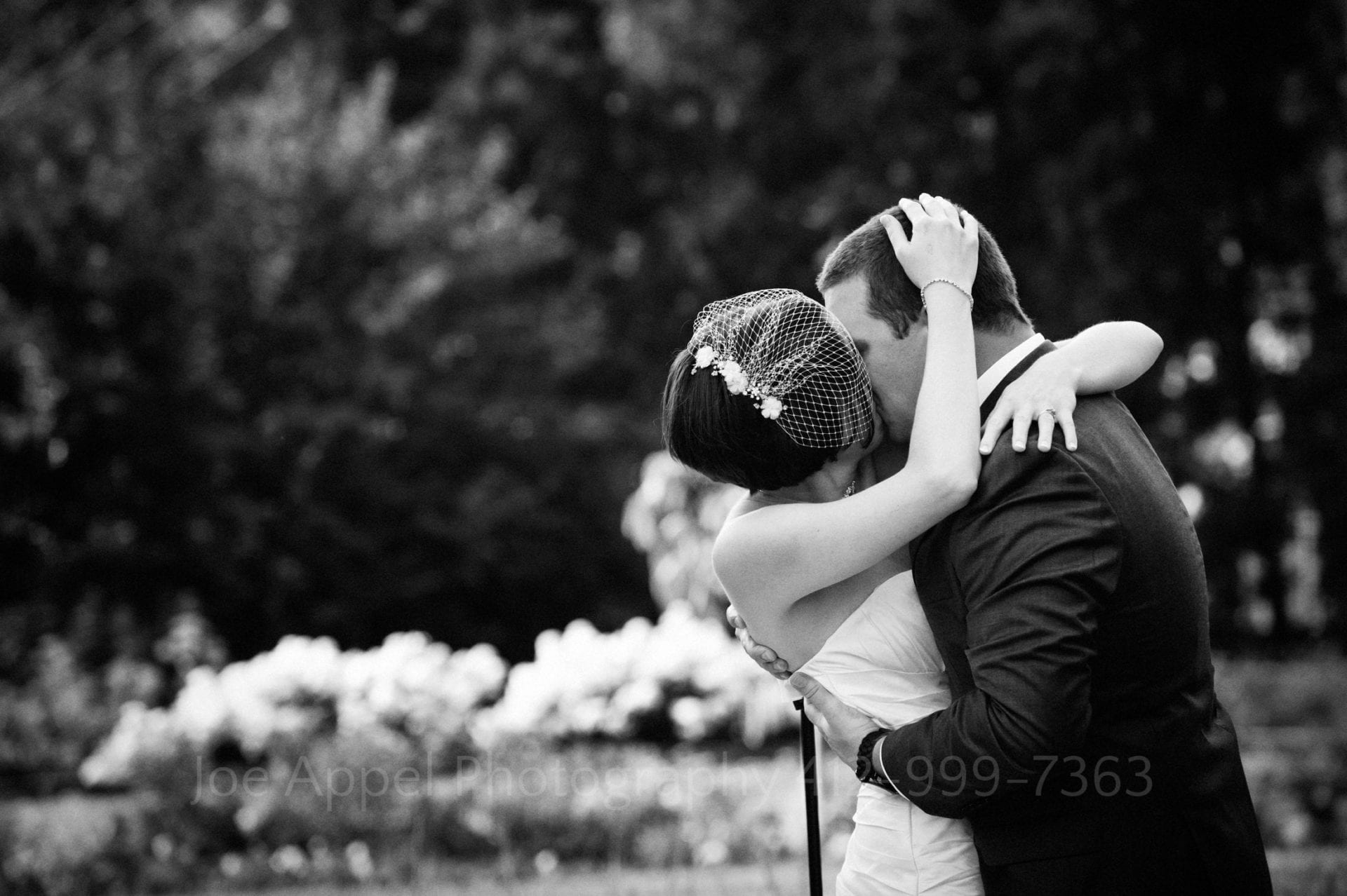 a bride and groom kiss in a garden Phipps Conservatory Weddings
