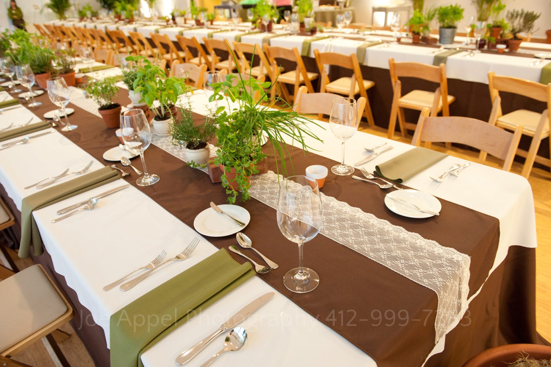 a dining table with brown and green napkins and runners Phipps Conservatory Weddings