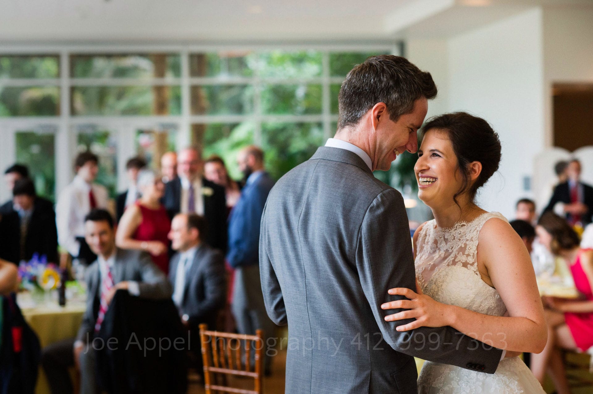 a bride and groom smile and dance Phipps Conservatory Weddings