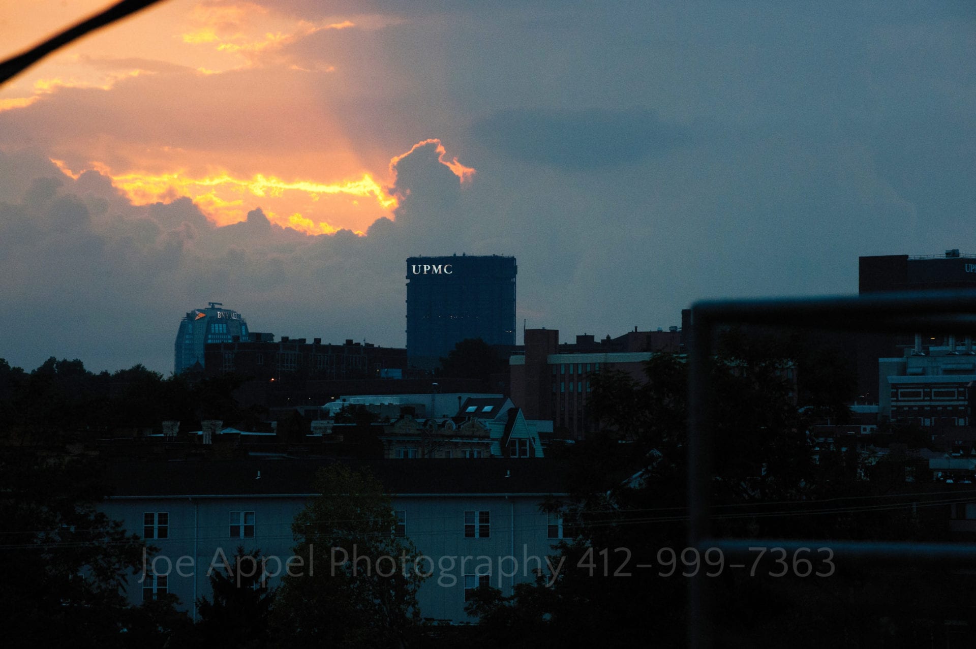 the skyline of downtown pittsburgh against a cloudy sunset Phipps Conservatory Weddings
