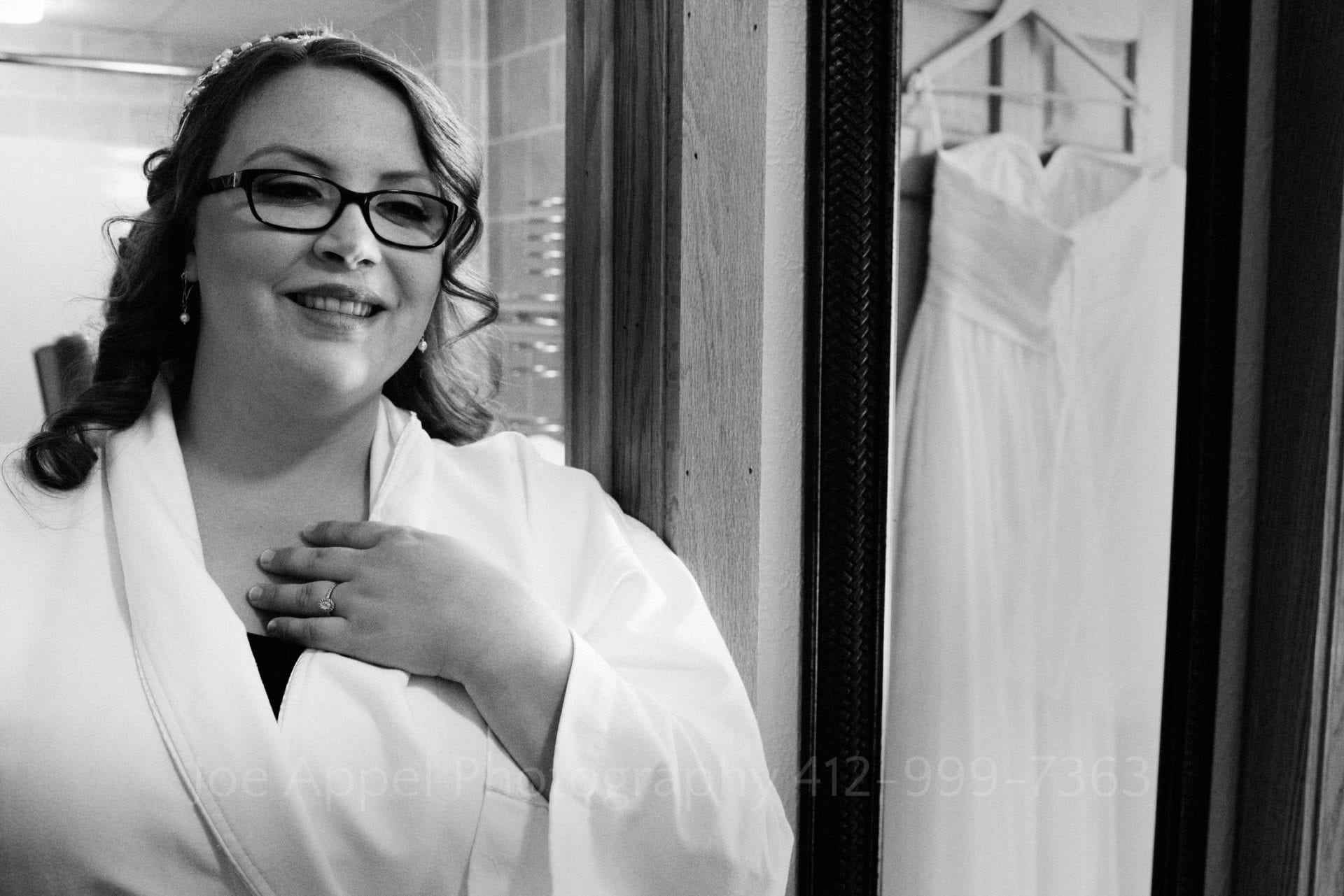 a bridesmaid in a white robe smiles Seven Springs Weddings