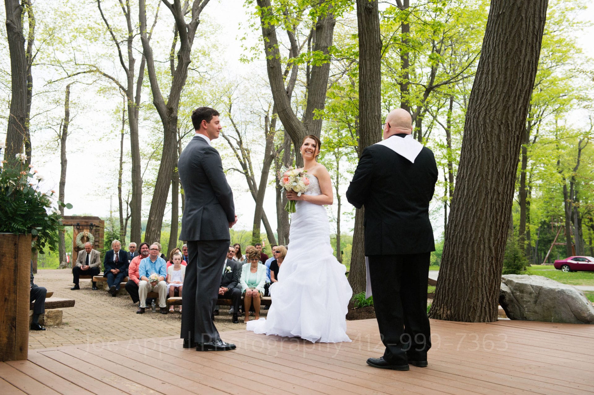 a bride and groom say their vows on an altar in the woods Seven Springs Weddings