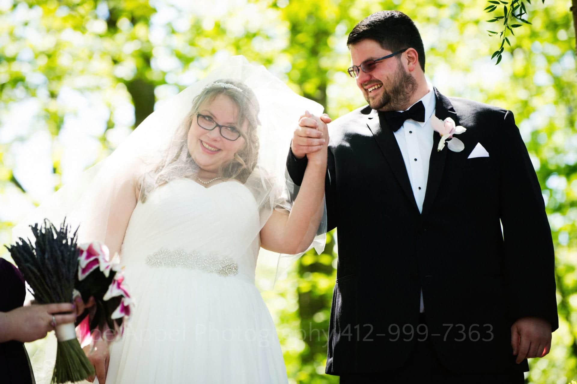 a bride and groom smile and hold hands Seven Springs Weddings