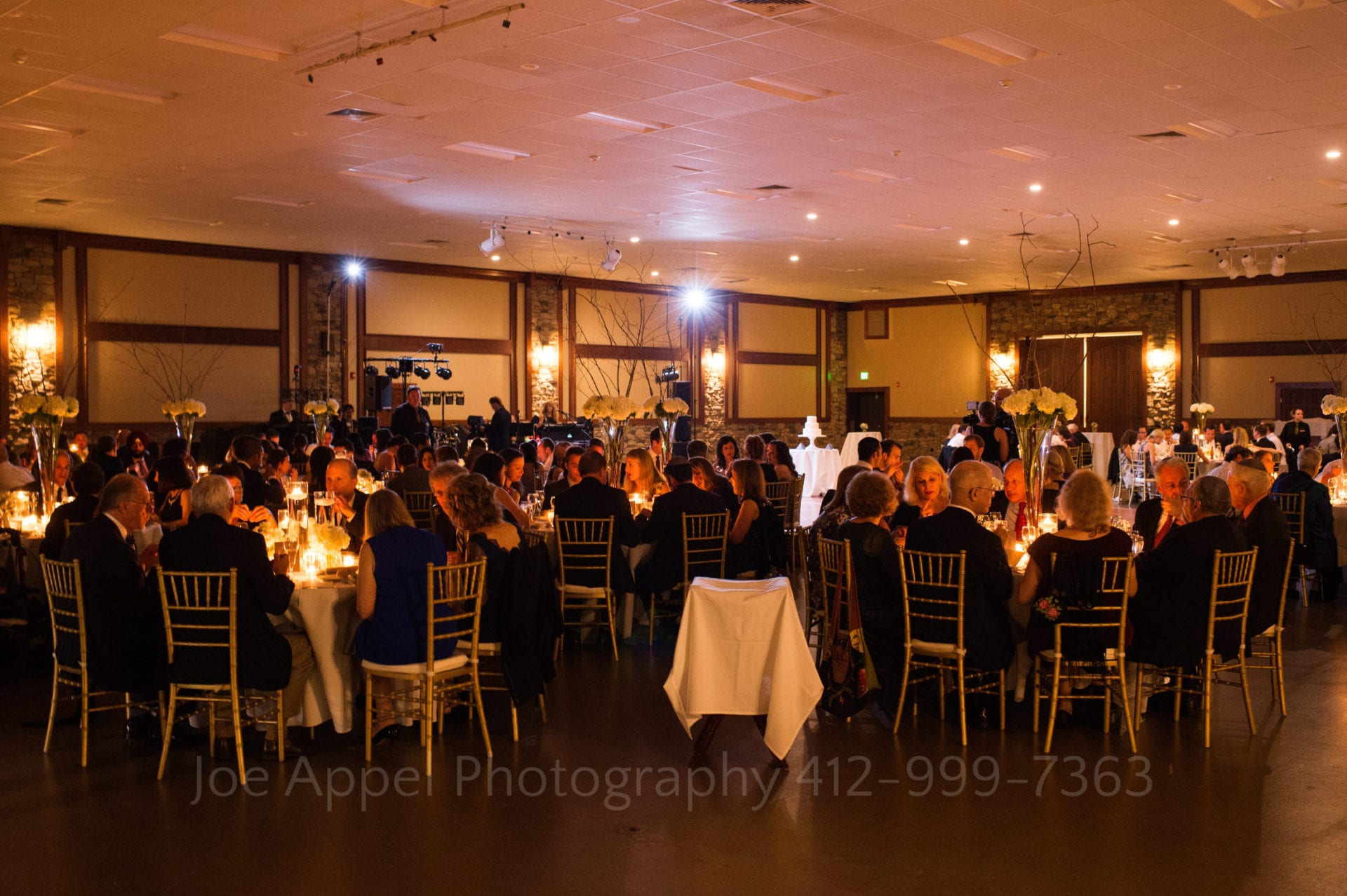 guests have dinner in an illuminated dining room Seven Springs Weddings