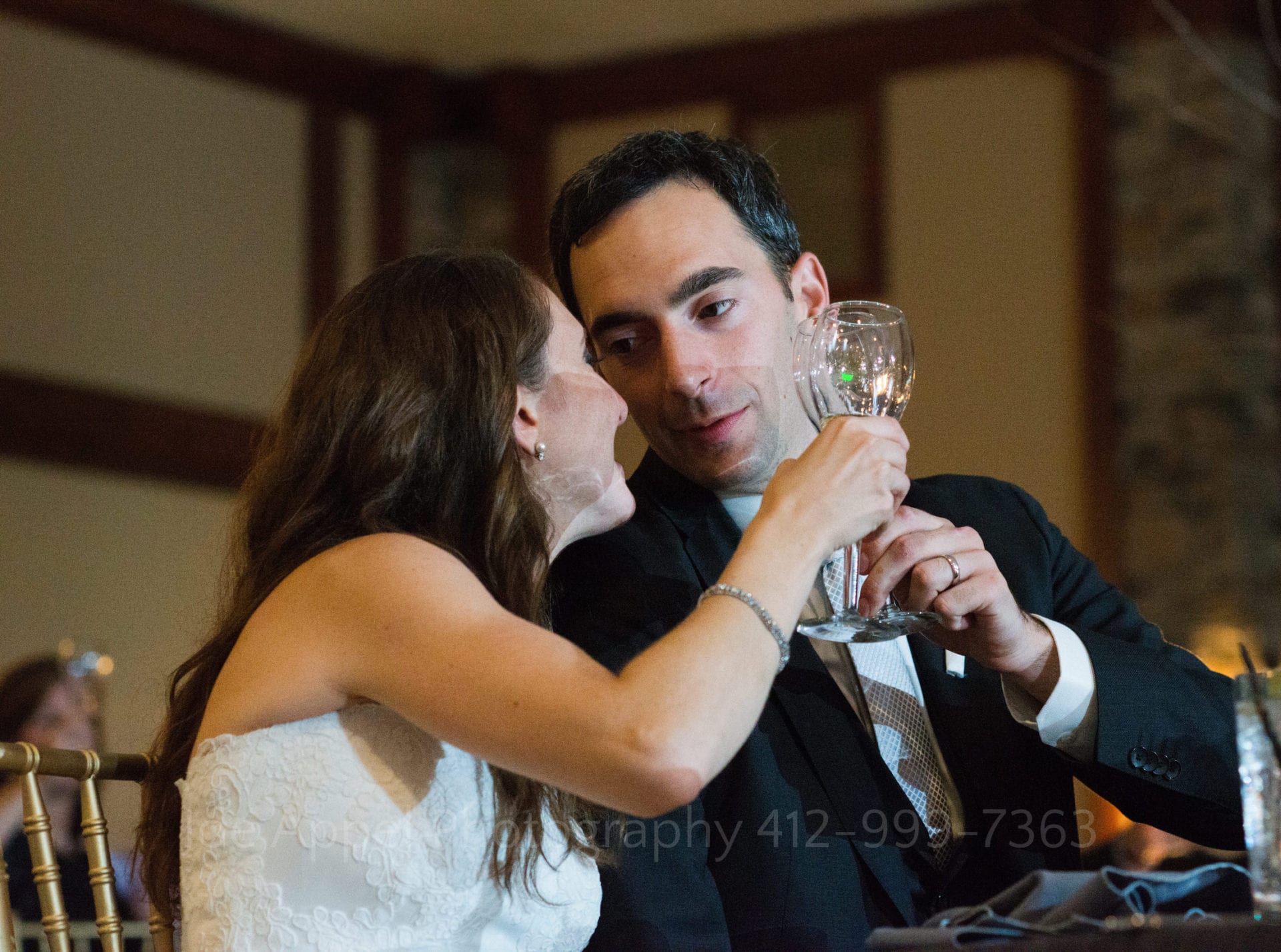 a bride and groom toast their glasses Seven Springs Weddings