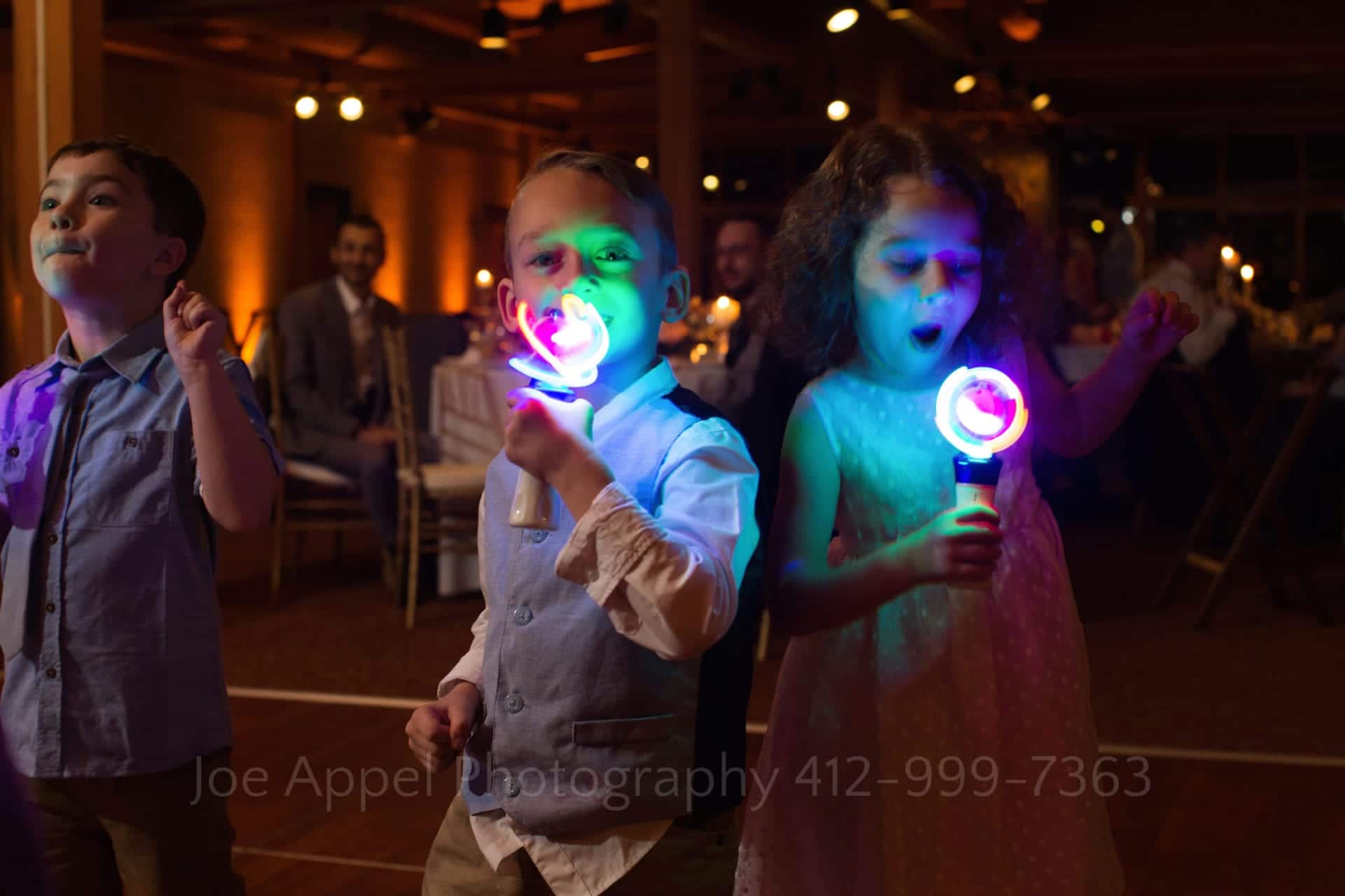 children play with rainbow light up toys Seven Springs Weddings