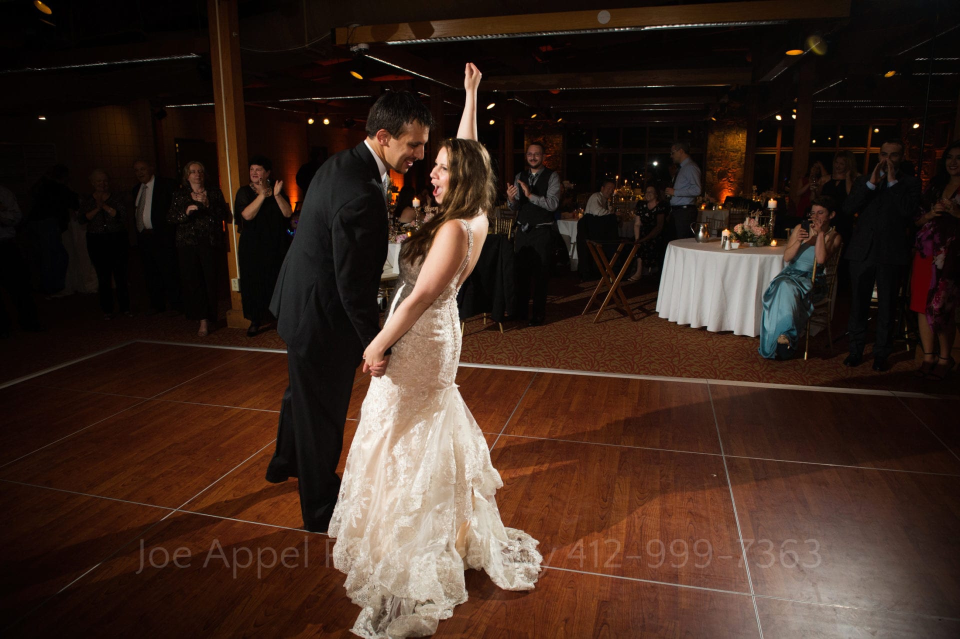 a bride in a lace white dress dances with her groom Seven Springs Weddings