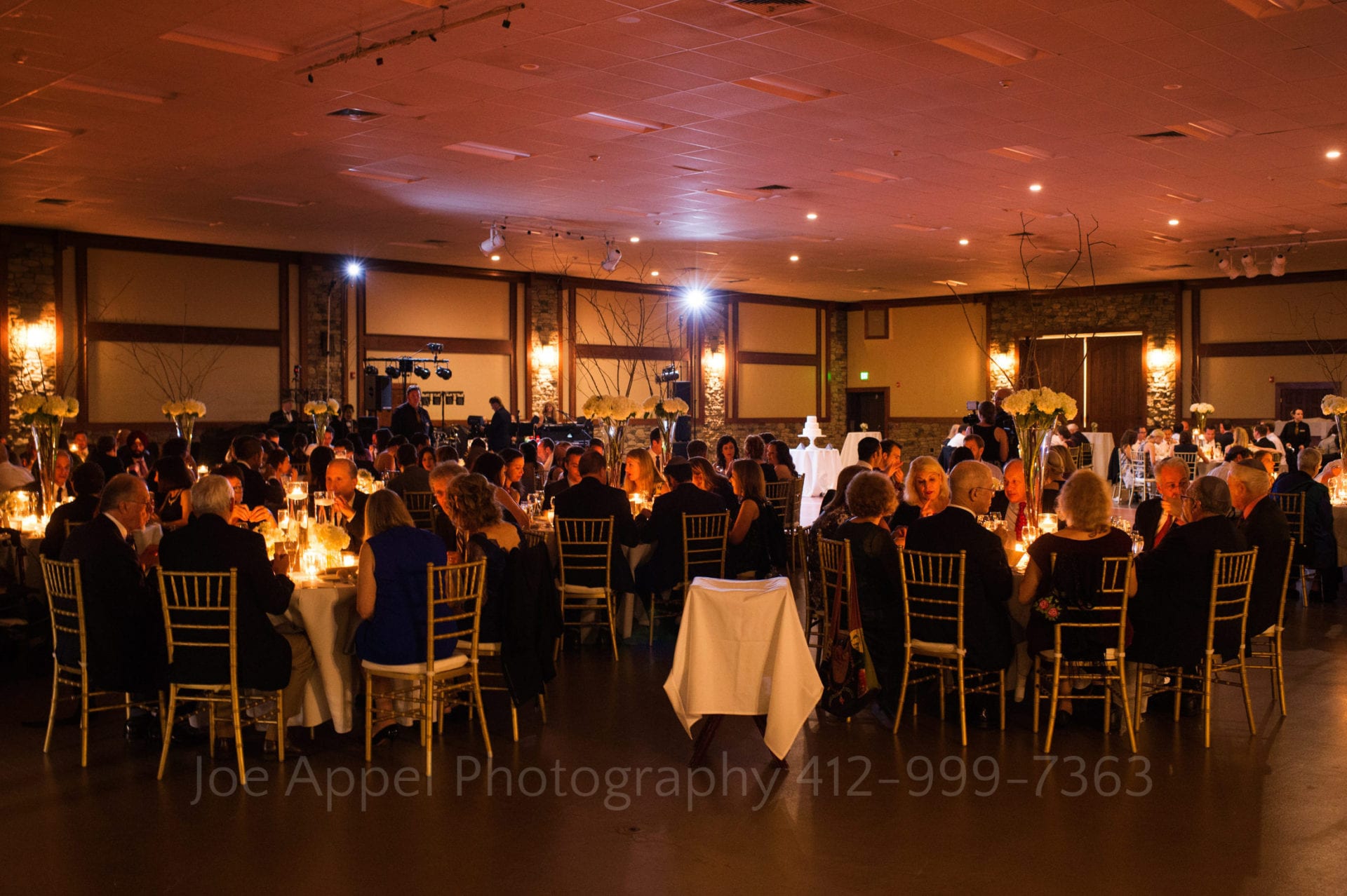 A candlelit ballroom filled with diners. Seven Springs Resort wedding.