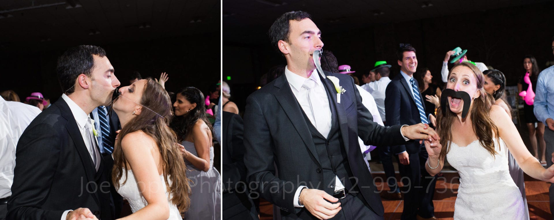 A bride and groom wearing giant fake mustaches kiss on a dance floor.