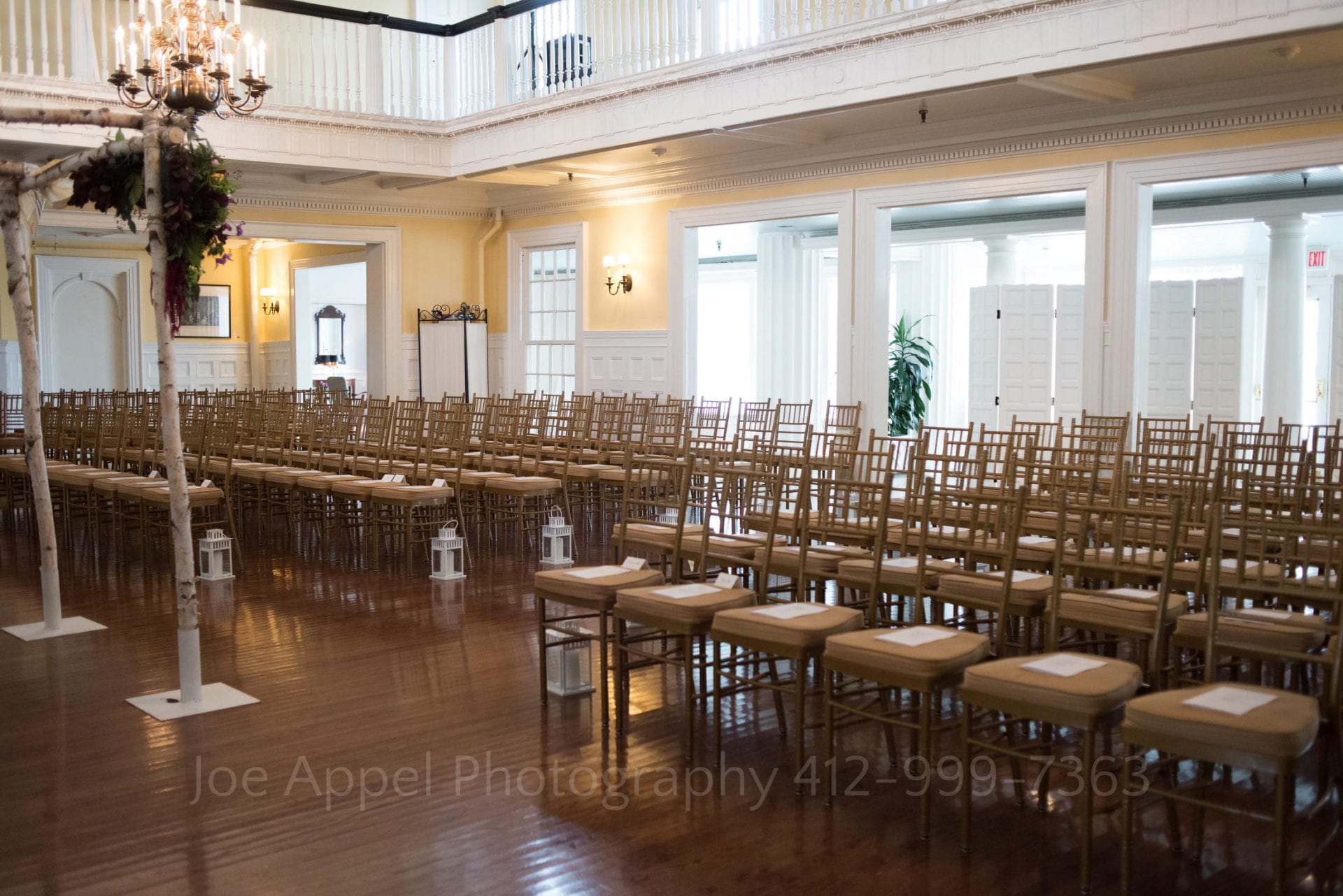 brown chairs with lanterns and an altar in a white room