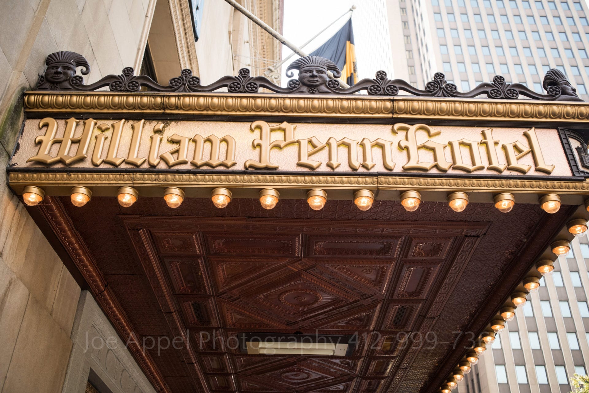 the gold entrance sign of the william penn hotel