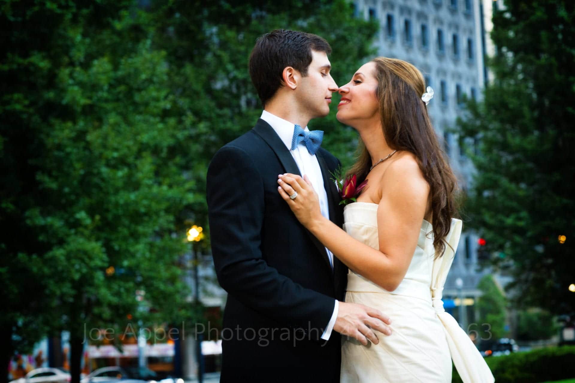 a bride and groom embrace in the city