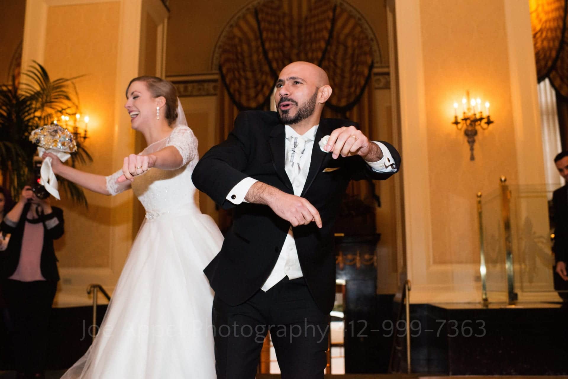 a bride and groom laugh and dance together