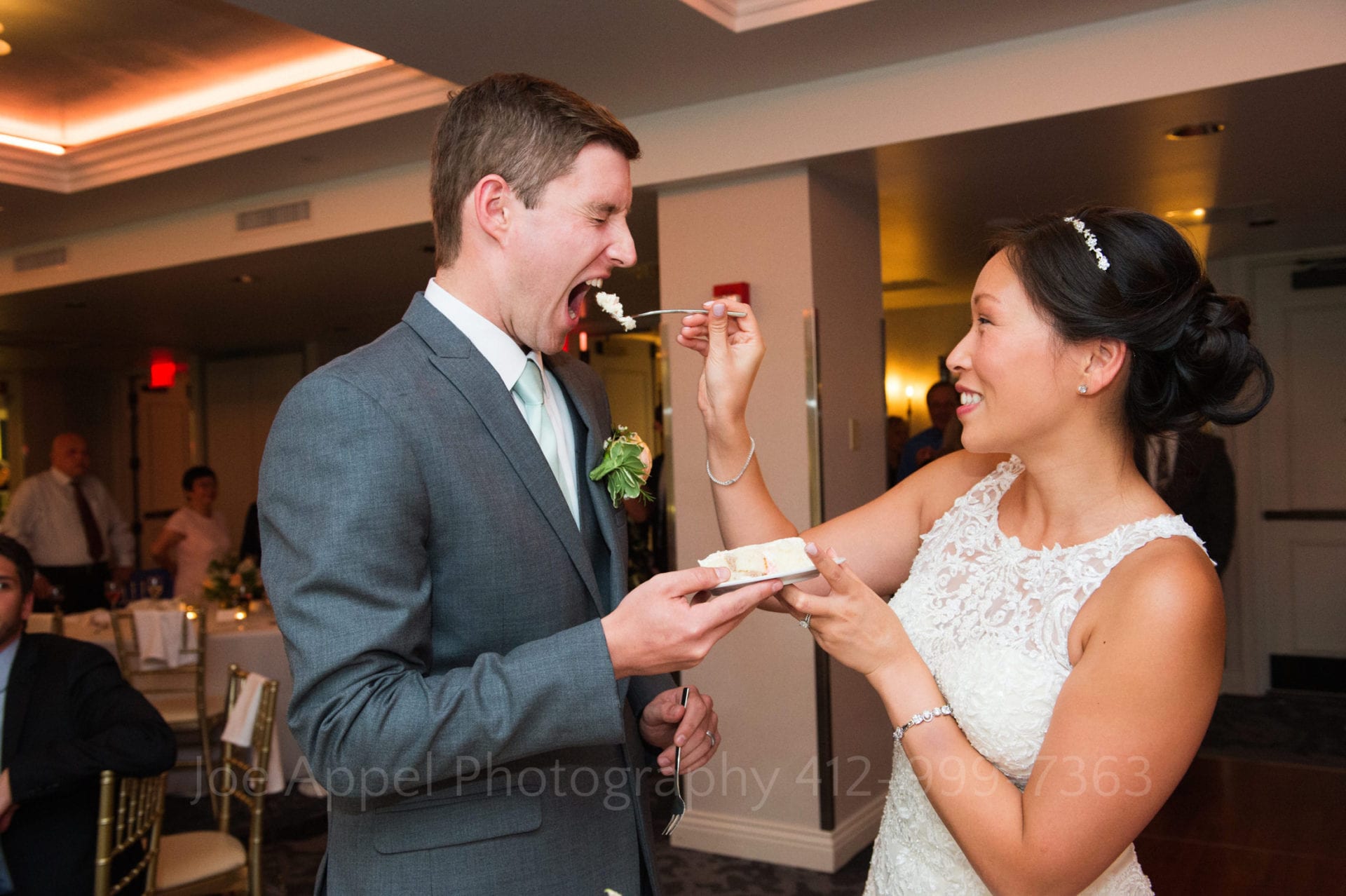 a bride feeds her groom a piece of cake