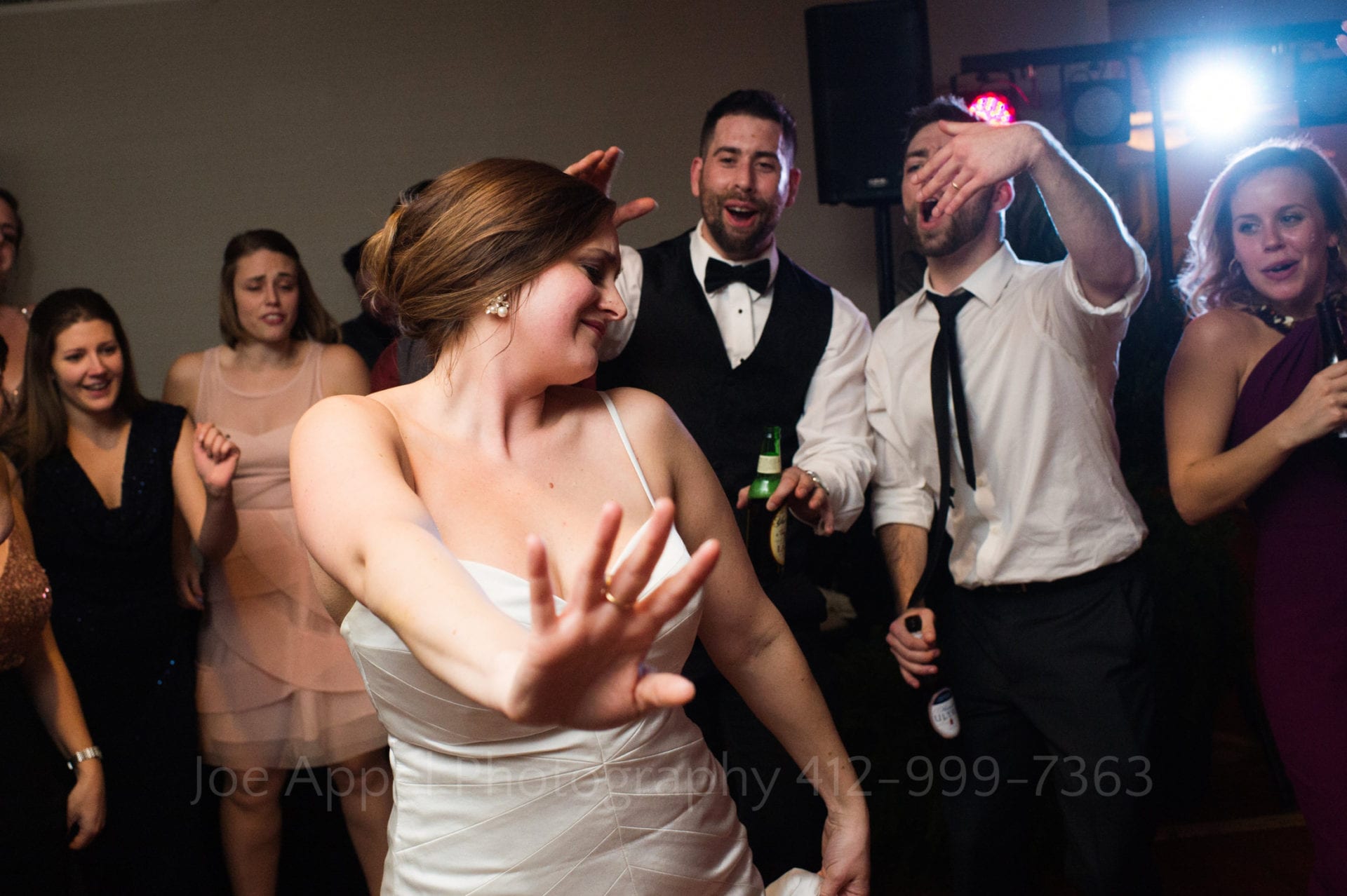 guests cheer as a bride dances
