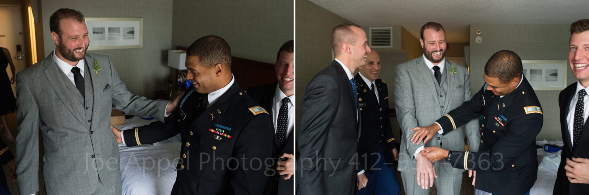 Men in uniform stand around and joke with a groom wearing a gray suit.