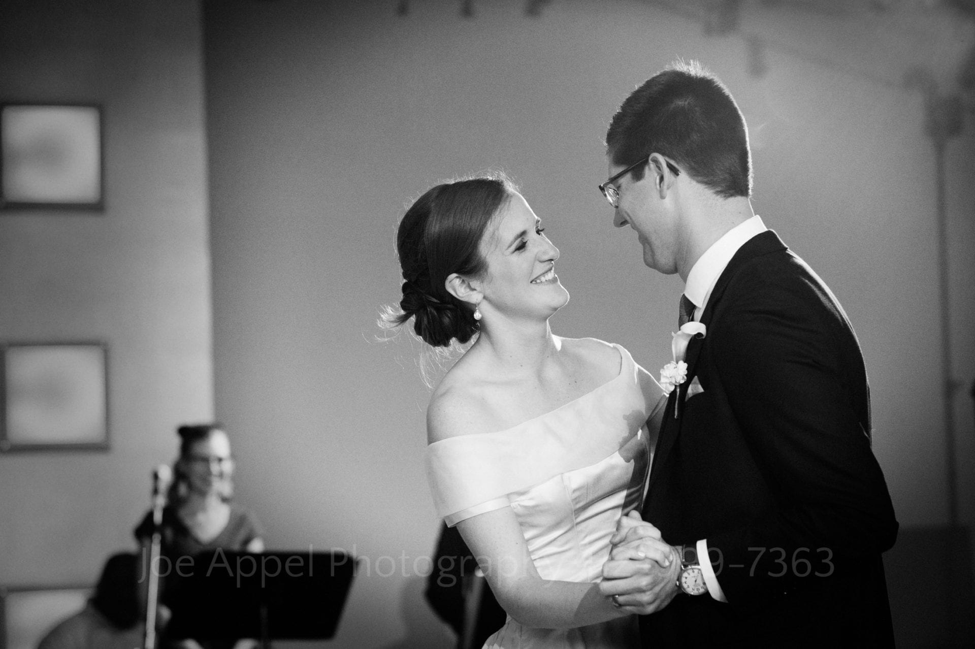 A smiling couple dances during their Heinz History Center wedding.