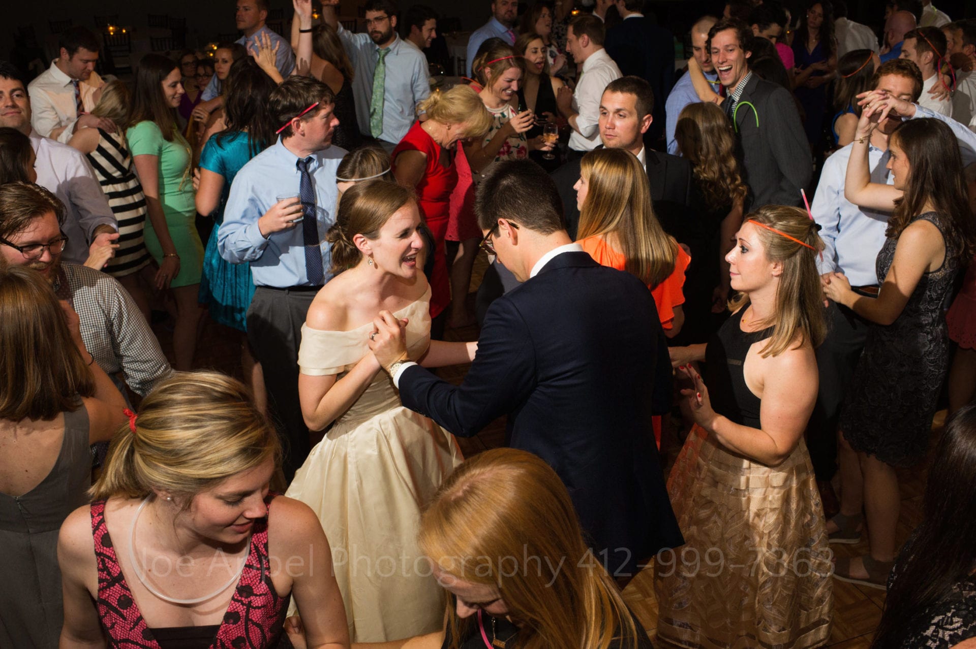 Seen from above, a bride and groom dance in the middle of large crowd of guests at their Heinz History Center wedding.