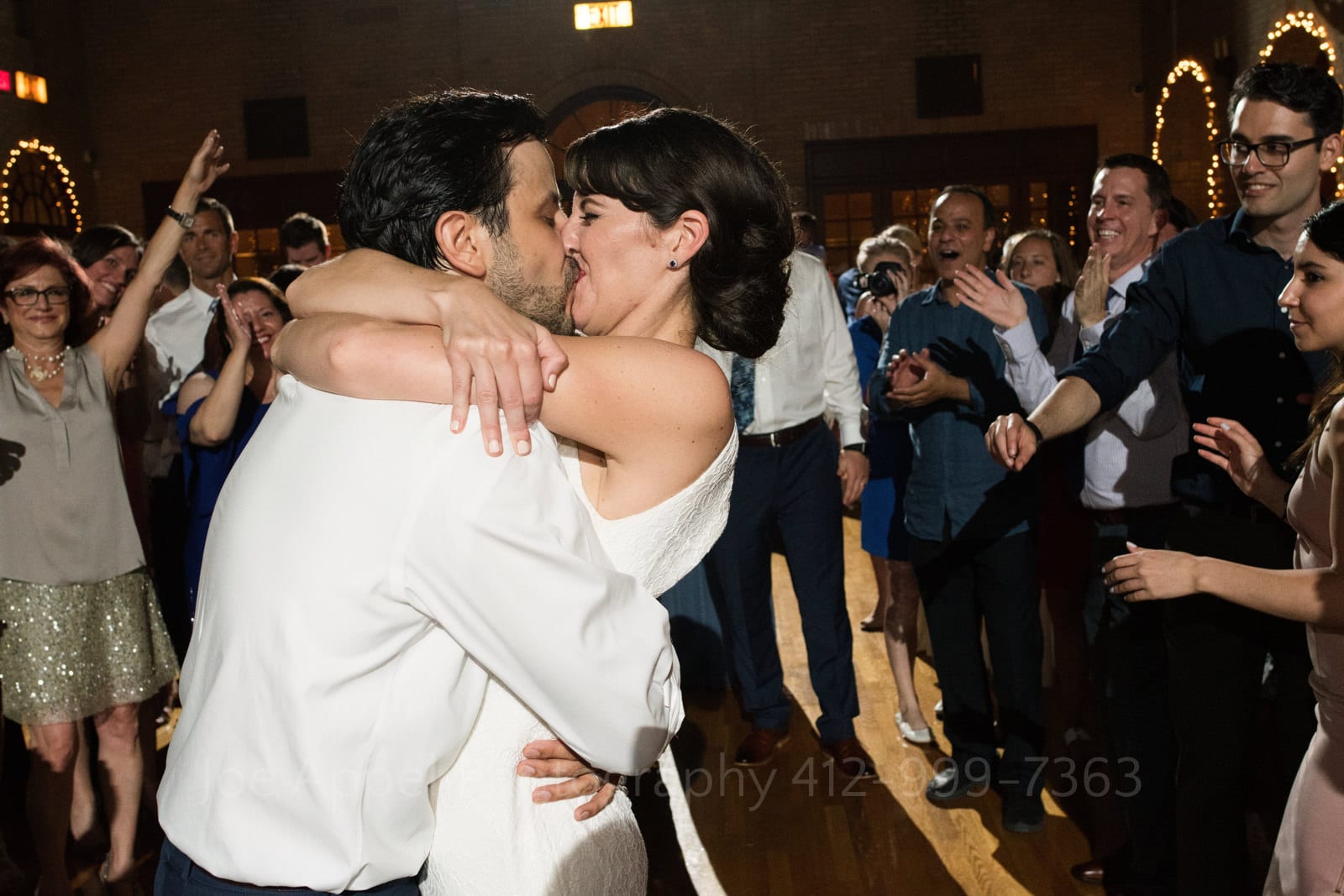 A bride and groom embrace tightly while they kiss on the dancefloor during their St Francis Hall Washington DC wedding.