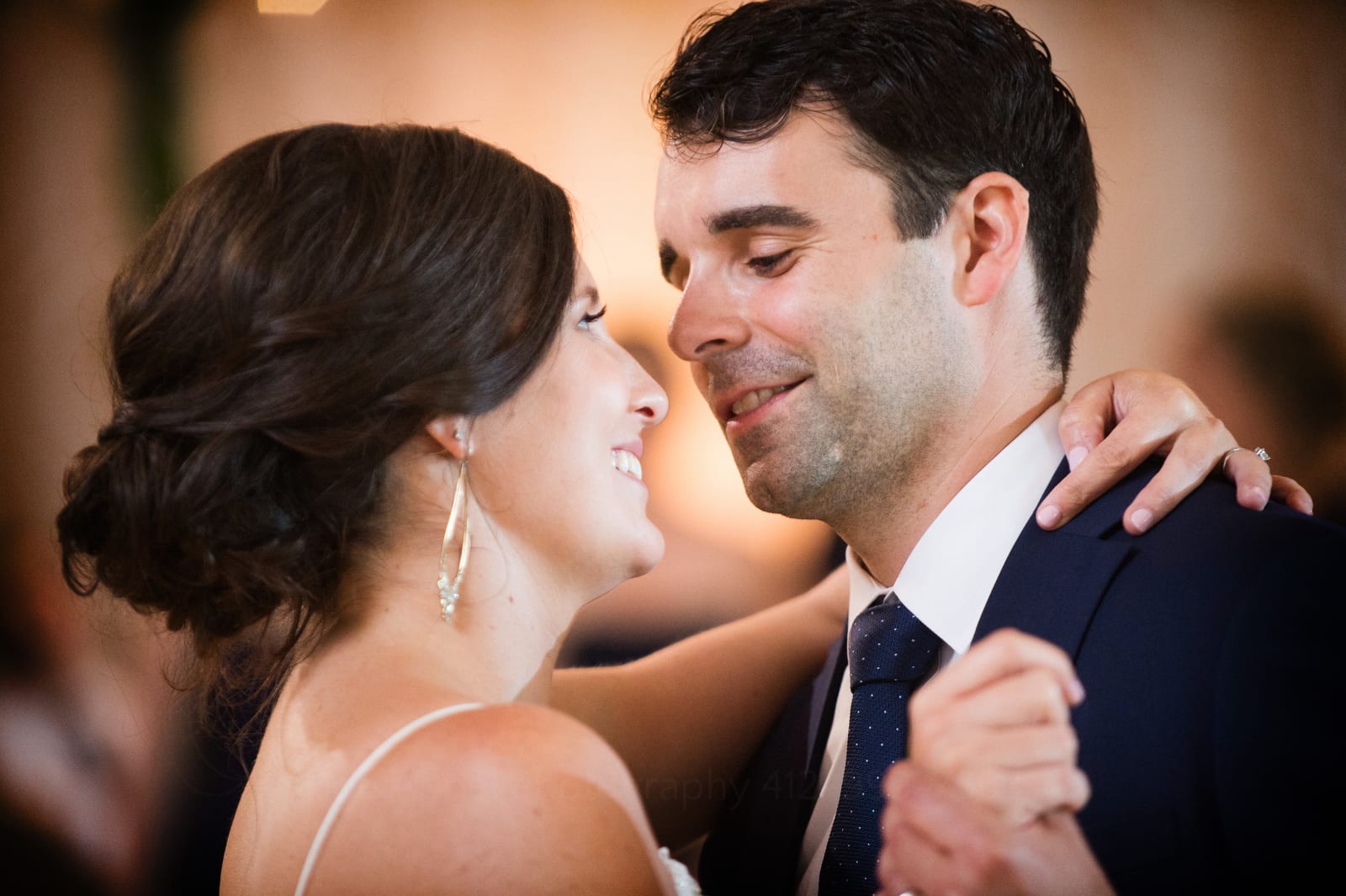 A closeup of a bride and groom smiling at each other while they're dancing Wedding Photography at Fairmont Hotel Pittsburgh.