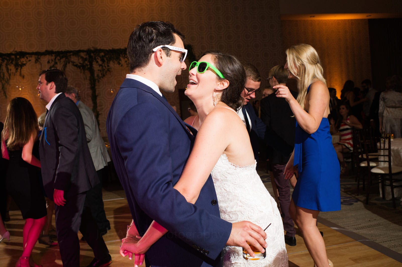 A bride and groom wearing sunglasses embrace on the dance floor of their Wedding Photography at Fairmont Hotel Pittsburgh.