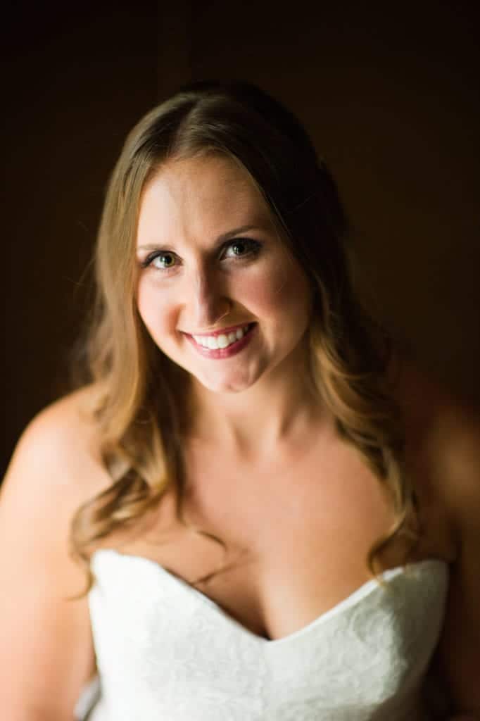A bride with long, curly blonde tresses smiles at the camera before her Hyeholde Wedding Pittsburgh.