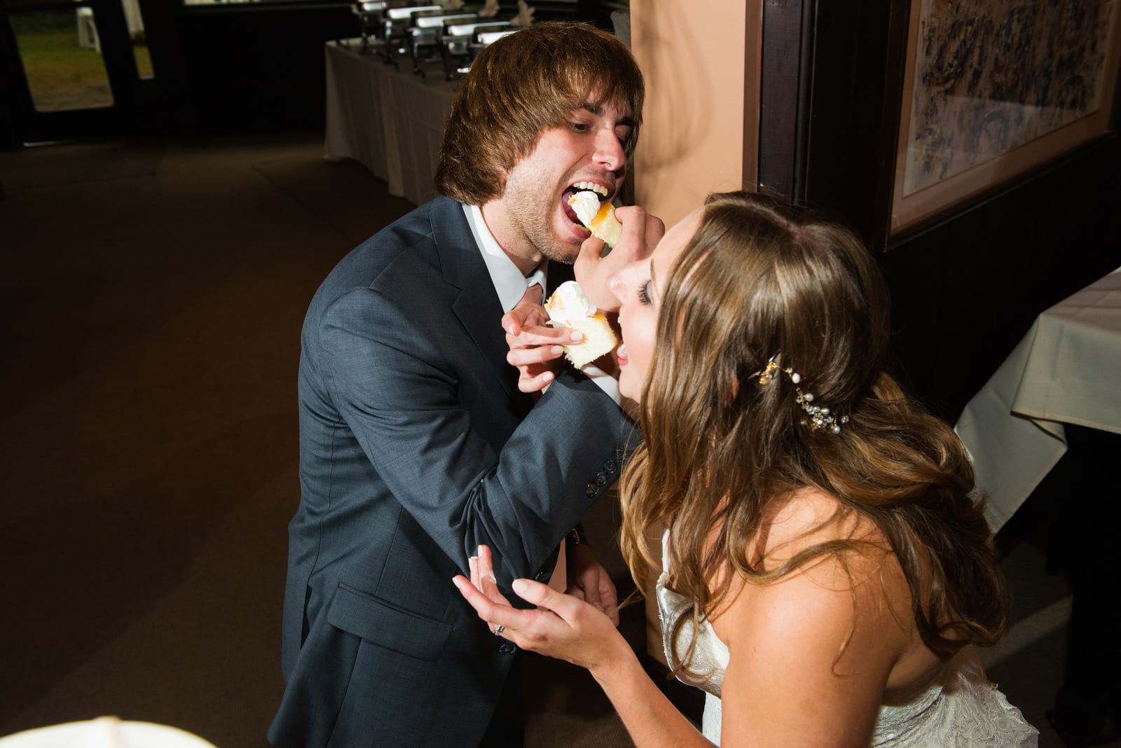 A couple links arms as they feed themselves a half of a cupcake during their Hyeholde Wedding Pittsburgh.