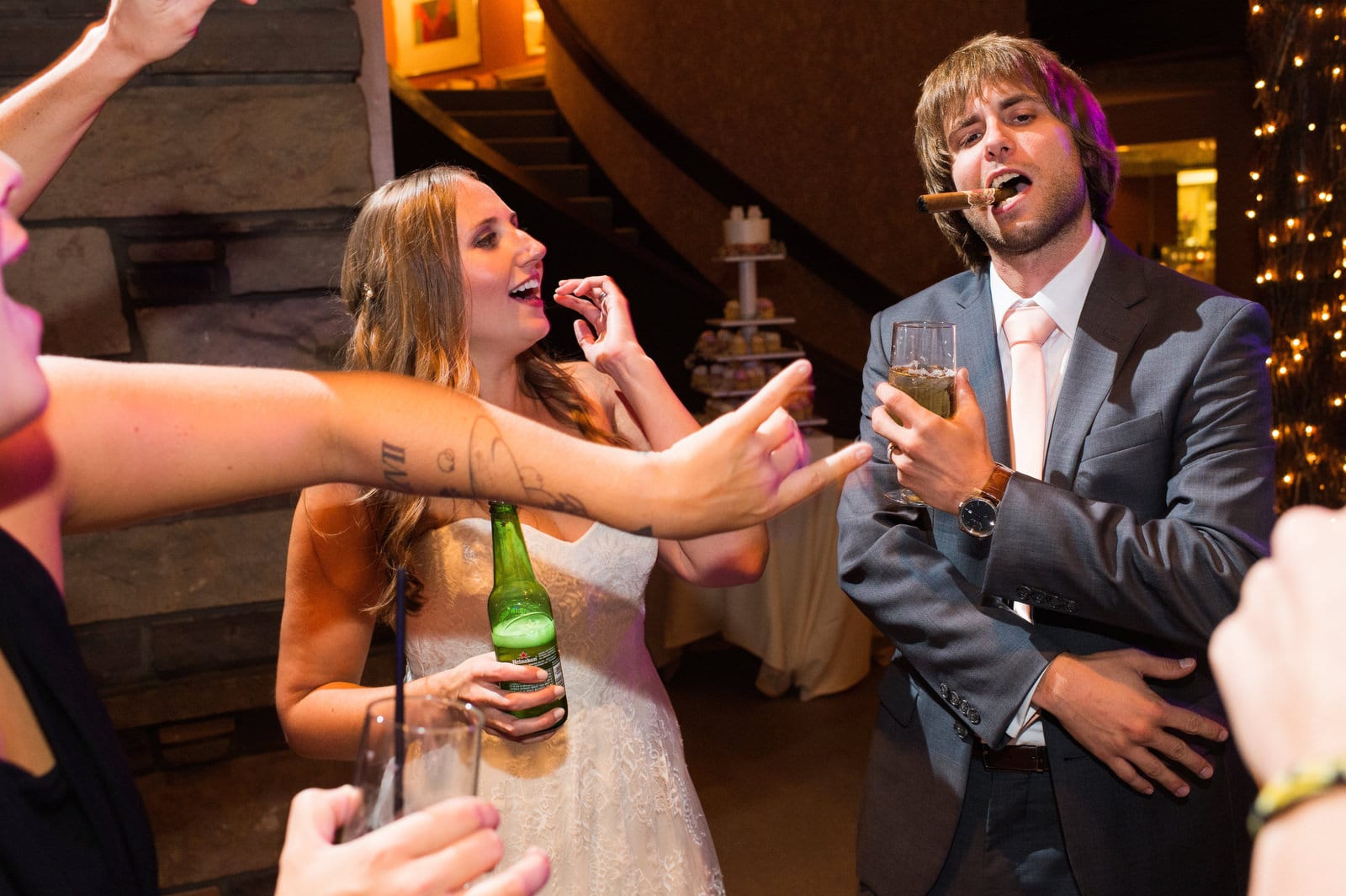 A bride and groom holding drinks dance with their guests during their Hyeholde Wedding Pittsburgh.