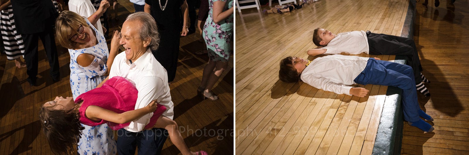A man holds a young girl as she flops backwards while they dance. Two boys lay on the edge of a stage with their legs dangling over during Soldiers and Sailors Wedding Photos.
