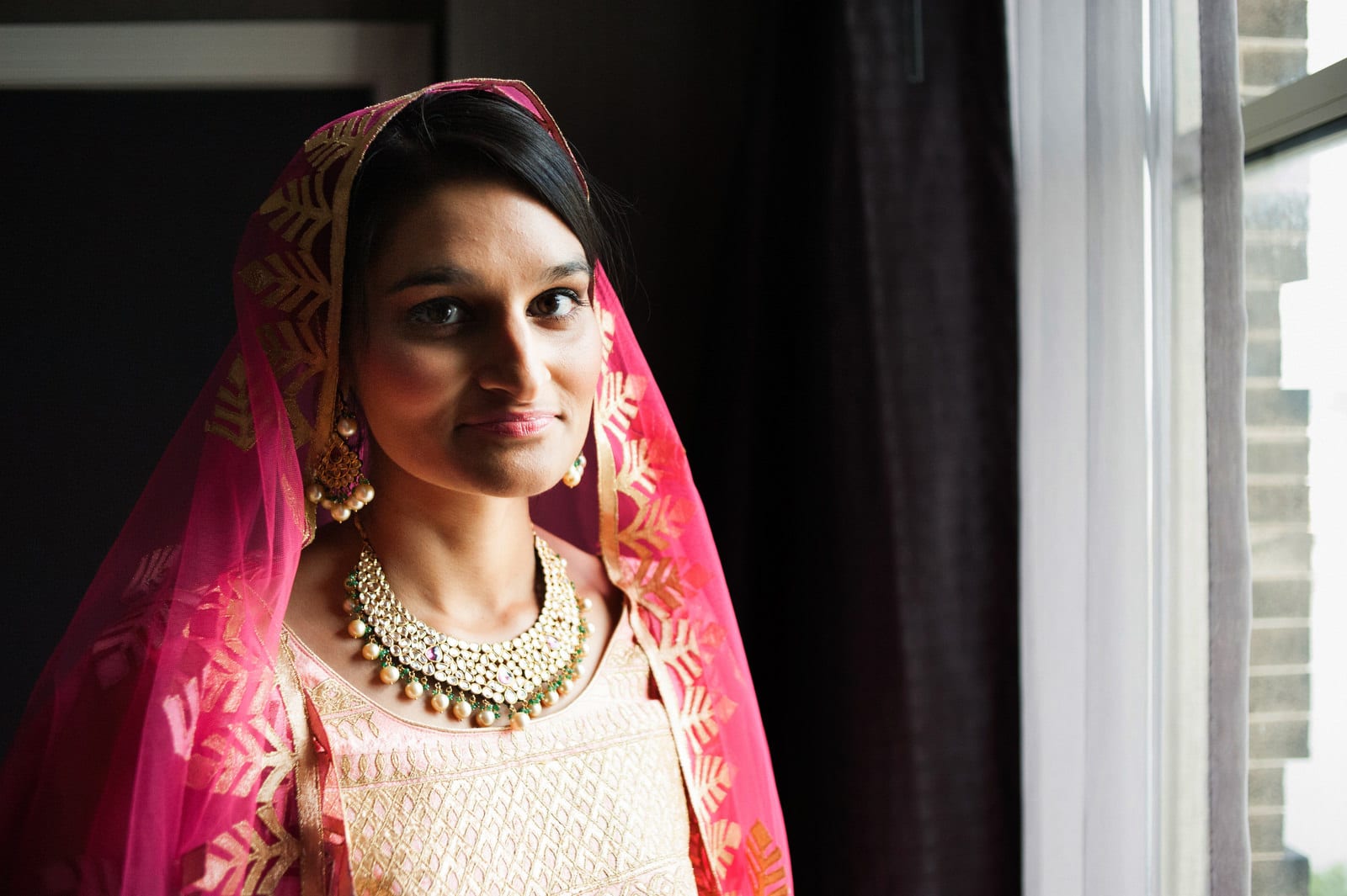 Portrait of a bride in a chartreuse and gold sari before her Renaissance Phipps South Asian Wedding.