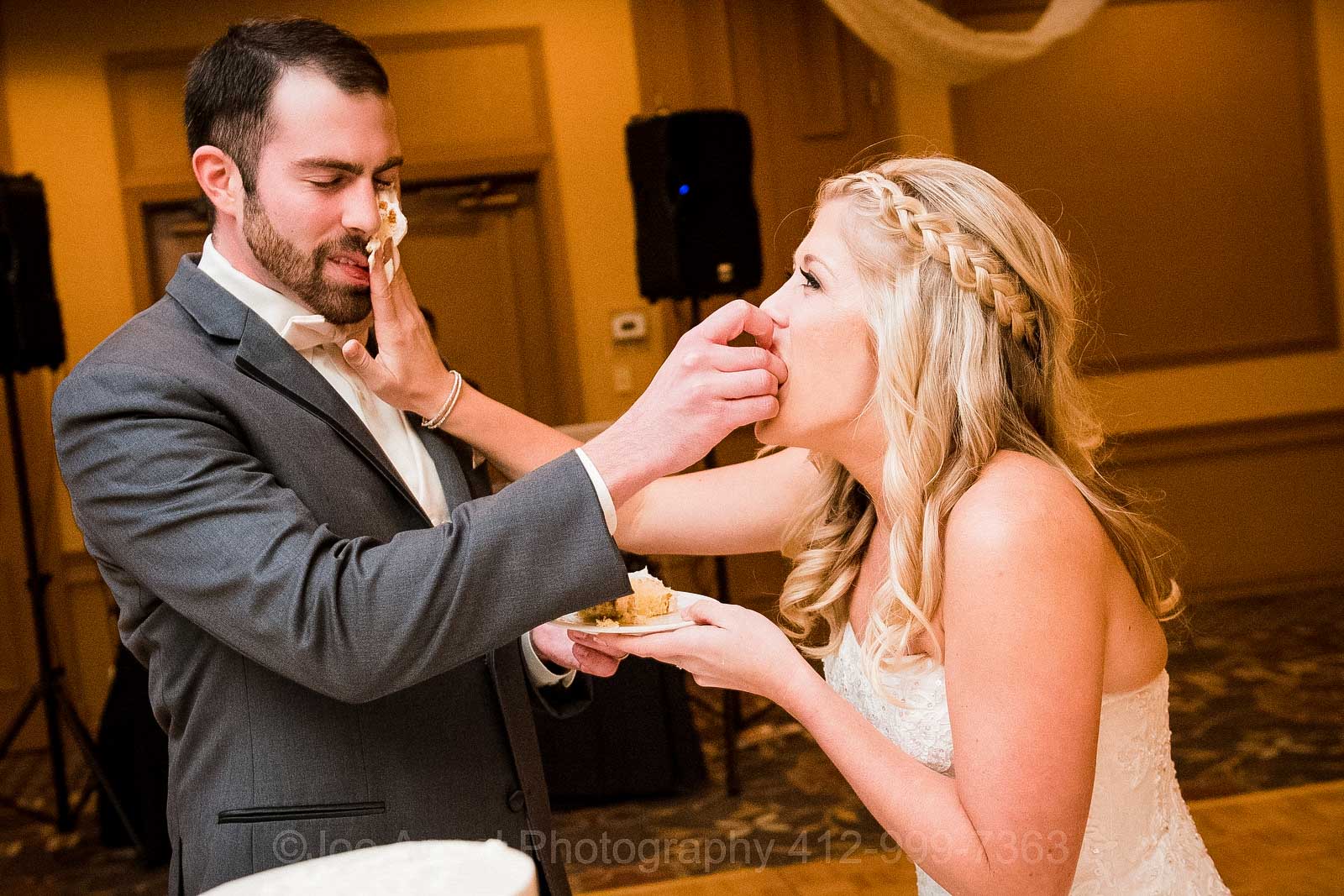 A bride smashes cake into her groom's face during their wedding reception at the Embassy Suites hotel near the Pittsburgh International Airport.