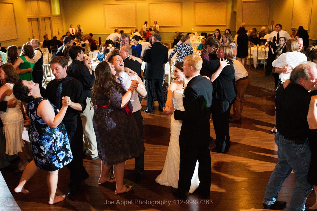 Seen from above, a bride and groom dance amongst their guests during their Montour Heights Country Club wedding.