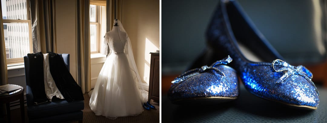 A wedding dress on a dress form by a window and a pair of blue sparkly shoes.
