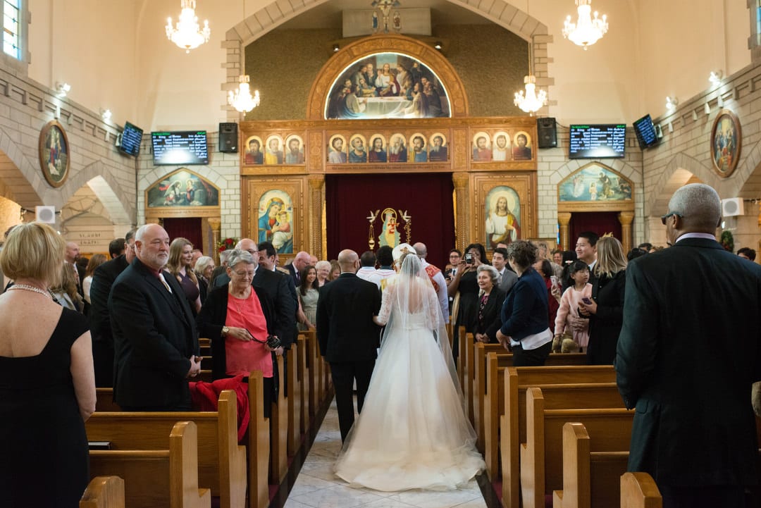 A bride and groom walk down the aisle at St. Mary's Coptic Orthodox church in Ambridge.