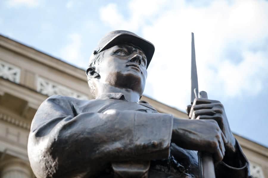 Close up photo of a bronze statue of a civil war soldier outside of Soldiers and Sailors Memorial Hall.