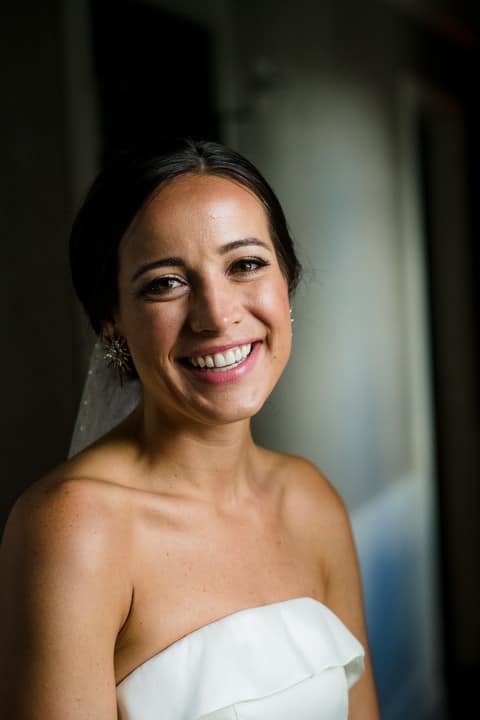 A bride looks at the camera and smiles.