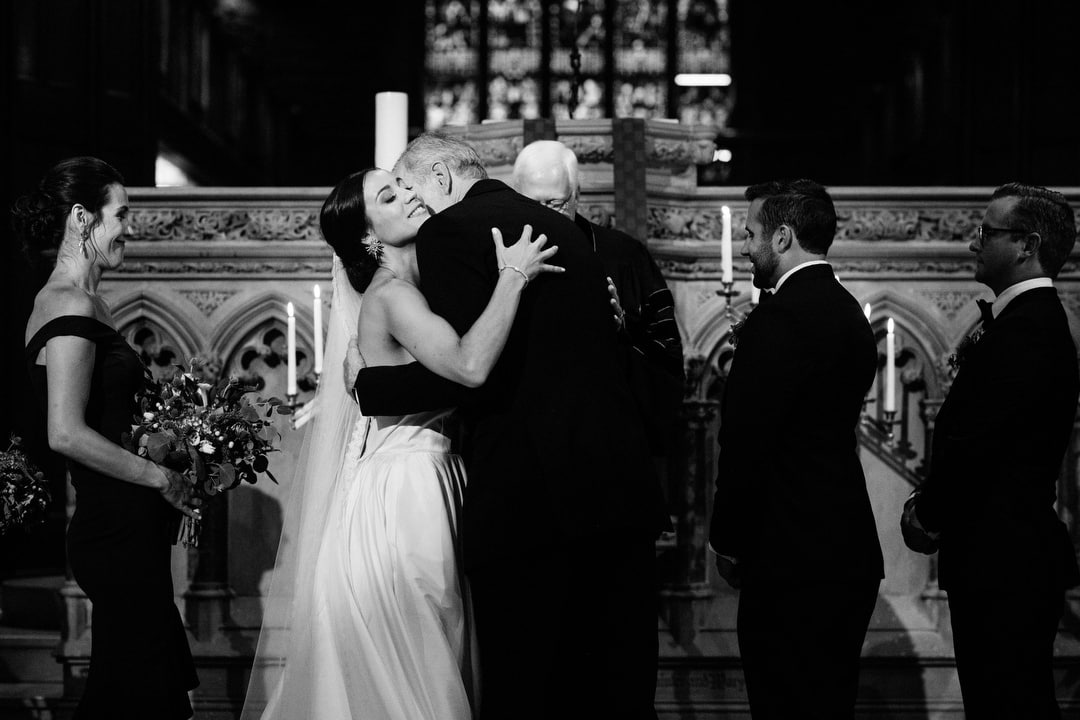 A bride hugs her father after walking down the aisle during a wedding at First Presbyterian Church in Pittsburgh.