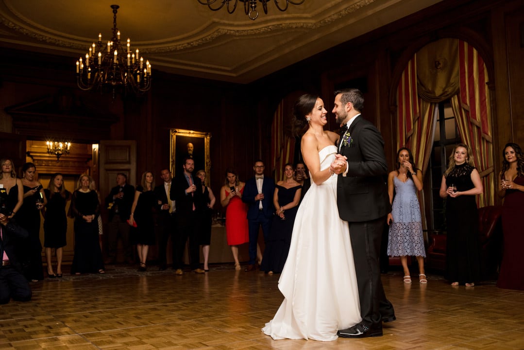 A bride and groom dance their first dance of their wedding in the founder's room at the Duquesne Club.