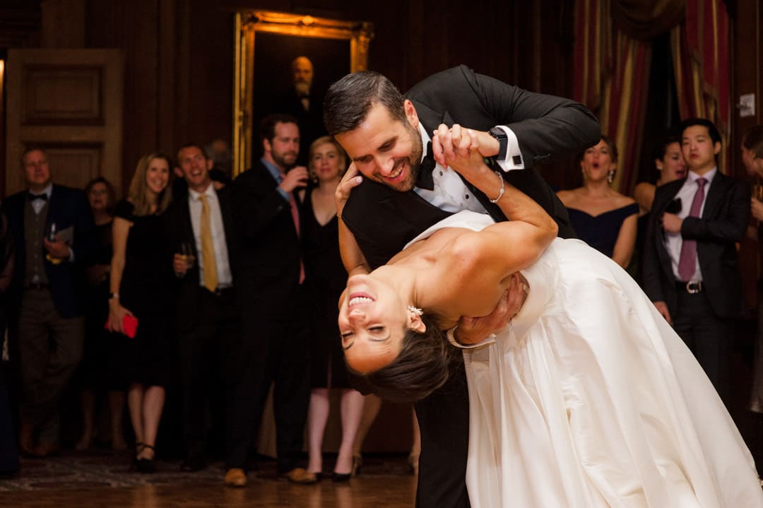 A bride is dipped by her groom at the end of their first dance during their Duquesne Club wedding.