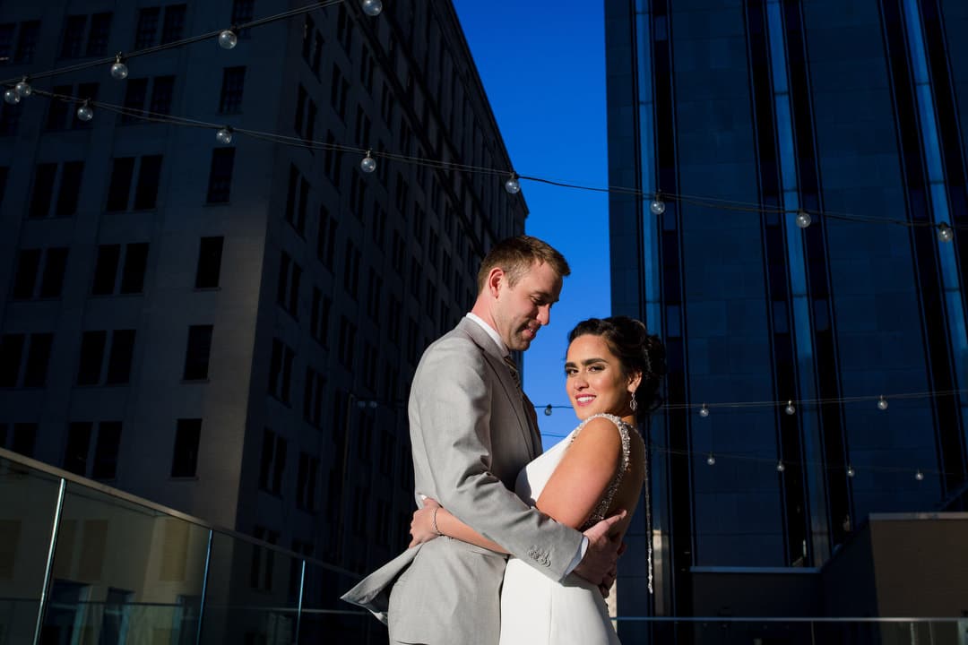 A bride and groom embrace on the roof of the Hotel Monaco in Pittsburgh.