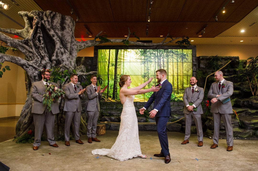 A bride and groom embrace at the end of their Pittsburgh Aviary wedding.