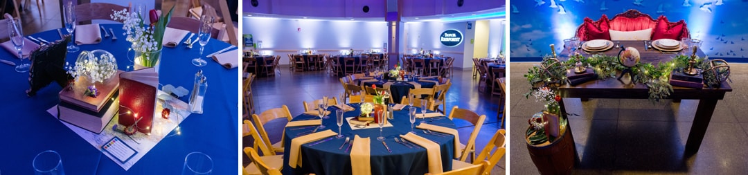 Blue table cloths and travel-related items on each of the tables in the atrium of the Pittsburgh Aviary during a wedding.