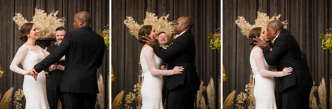 A bride and groom kiss at the end of their wedding ceremony at the Hotel Monaco Pittsburgh.