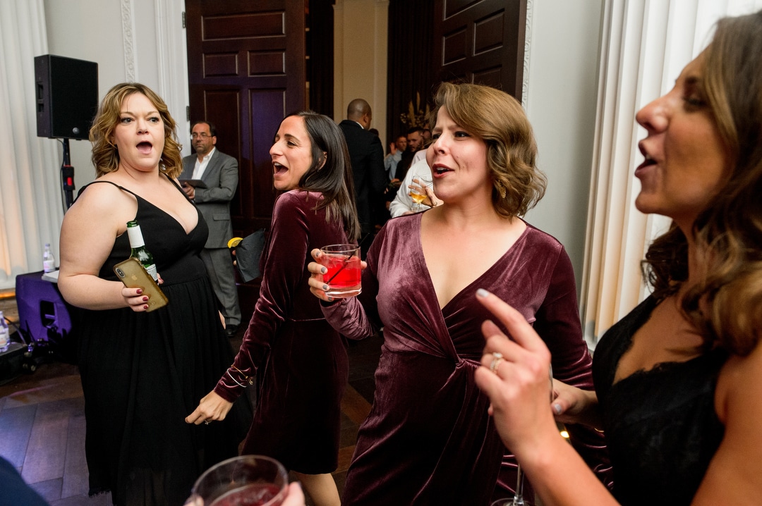 Women sing and dance together during a wedding at the Hotel Monaco in Pittsburgh.