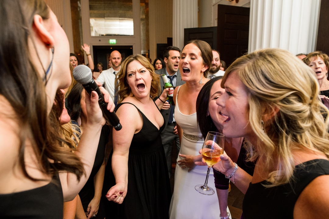 A bride sings and dances with her friends during a wedding at the Hotel Monaco.