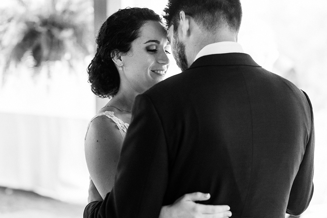 A bride and groom embrace during their first dance. The bride has a small smile on her face and closed eyes. This is the type of image that these folks will treasure for the rest of their lives. It's that kind of meaning that the world's best wedding photos all have in common.