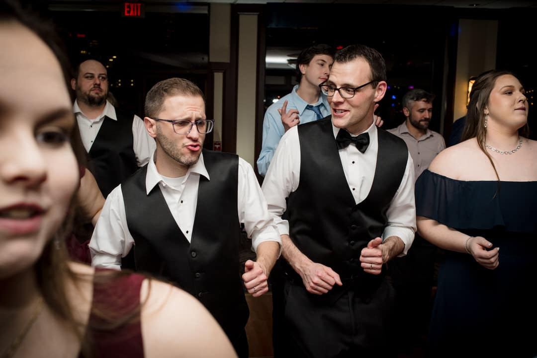 Two grooms with their shirt sleeves rolled up dance during their wedding at the Sheraton Station Square in Pittsburgh.