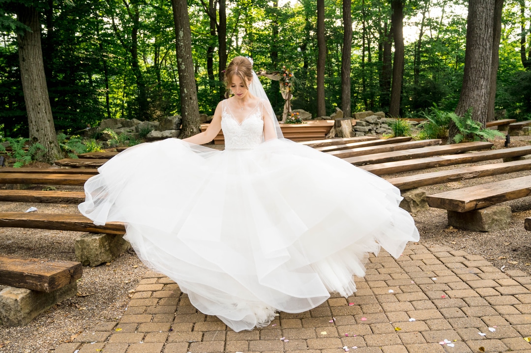 a bride twirls as her dress fans out