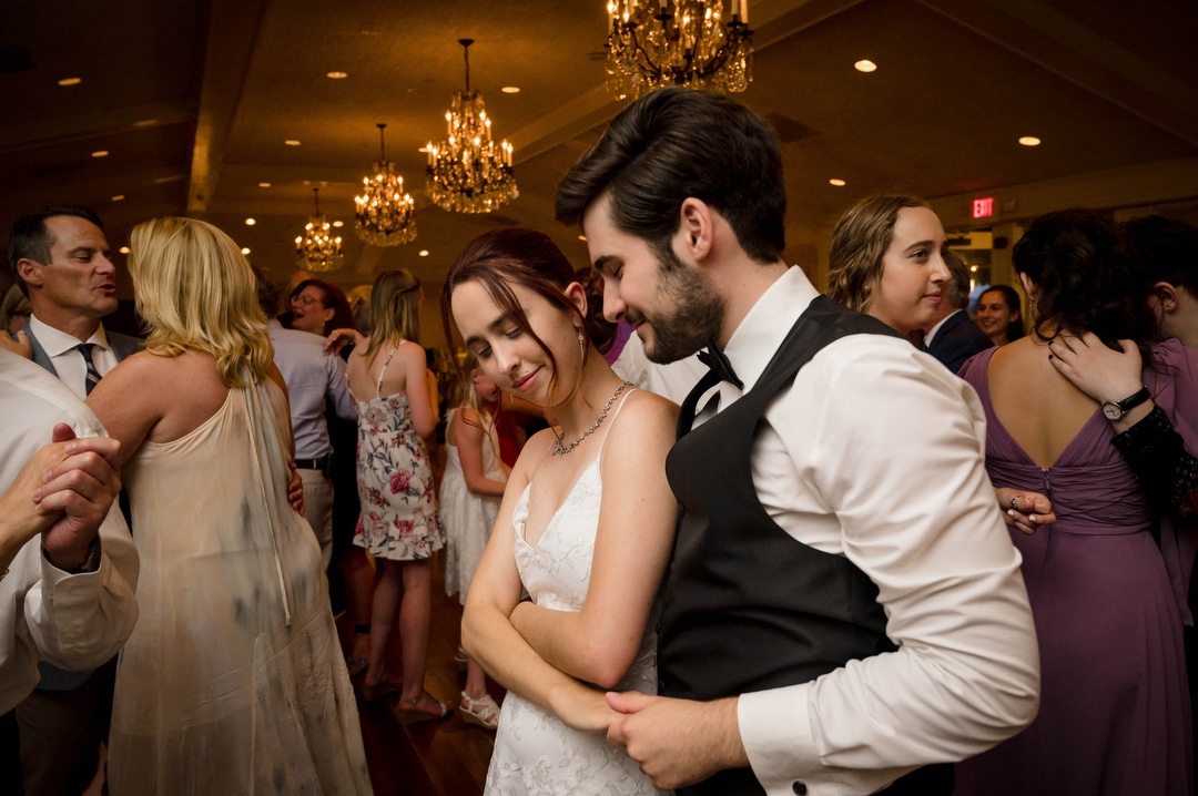 A bride and groom dance during their wedding reception at Oakmont Country Club.