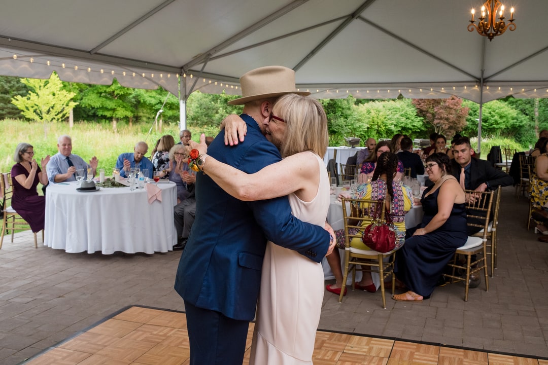Groom dances with his mom during a wedding at the Gardens of Stonebridge.